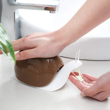 Portable soap dispenser in snail shape for easy handling and use.